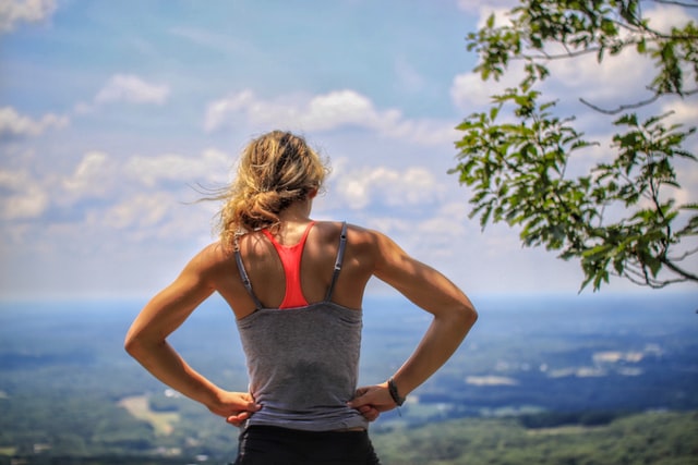 woman standing on mountain getting ready for a run create a morning routine