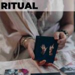 woman wearing white dress holding tarot cards how to celebrate a new moon ritual