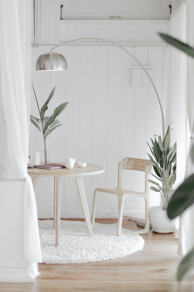 picture showing a bright room in white colours with natural light and floor lamp home yoga space