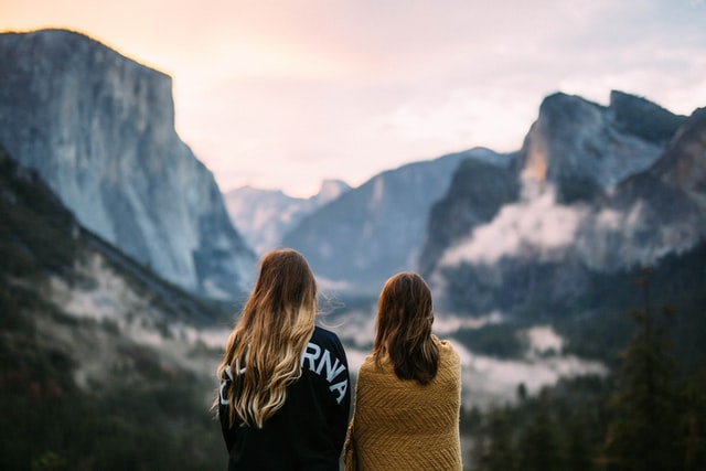two women standing in mountain setting enjoying a moment in nature intentional living