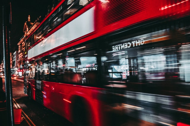 London bus passing by in evening city setting rushing intentional living