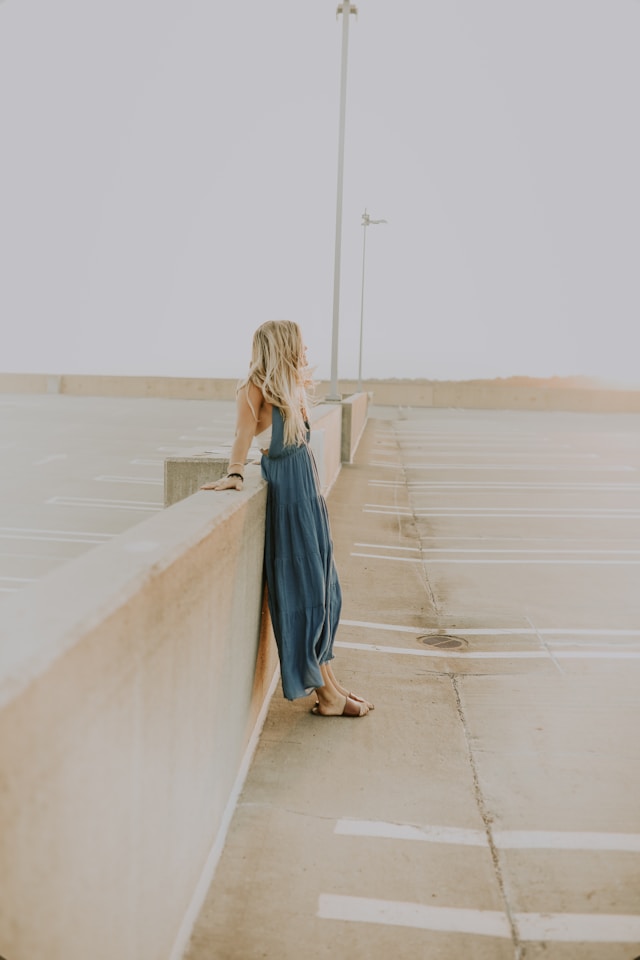 image features a woman with long blonde hair standing on a street looks like a pier blog post is about how to live an intentional life