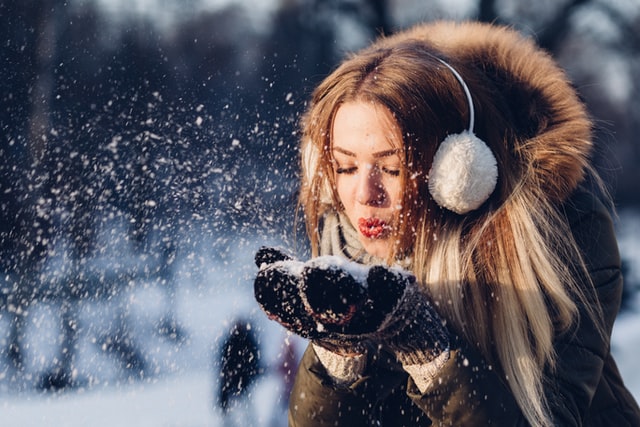 blond girl in with ear muffs winter walk self-care ideas