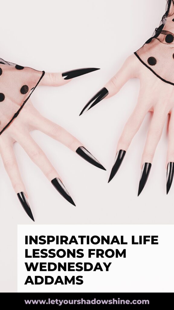 The Pinterest pin shows two female hand with black pointy finger nails the image has a gothic feel and the blog post is about inspirational life lessons from Wednesday Addams