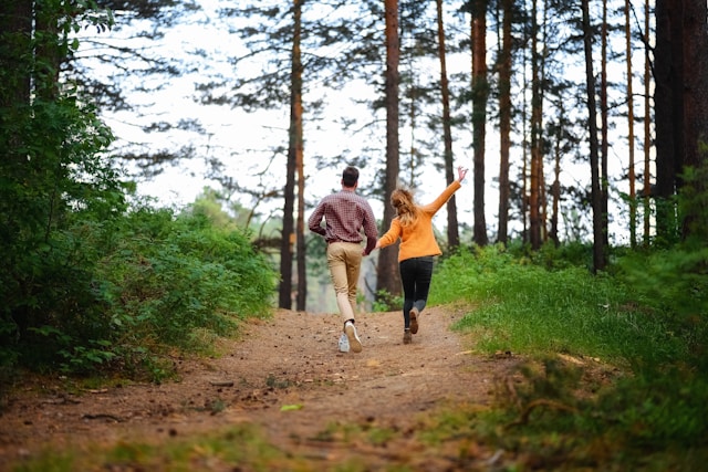 the picture shows a couple walking down a path in the forrest and the blog post is about gratitude activities for families