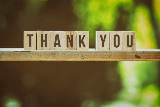 the image shows the words Thank You in standing single letters with green leaves in the background and the blog post is about gratitude activities for kids