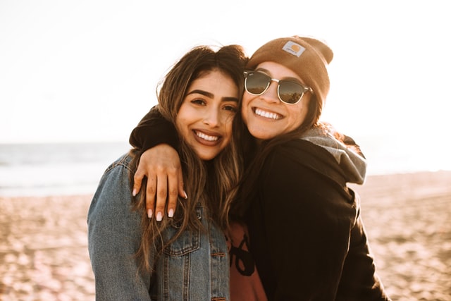 the image is showing two young women hugging and smiling the blog post is about the importance of cor values in life 