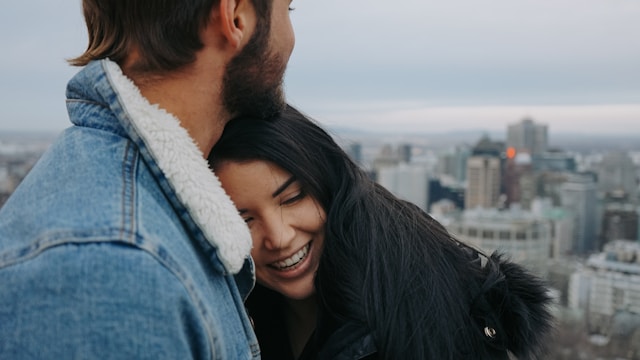 the image is showing a young couple man and woman hugging each other the woman is smiling and the man is enjoying a view onto the city the blog post is about the importance of core values in life 