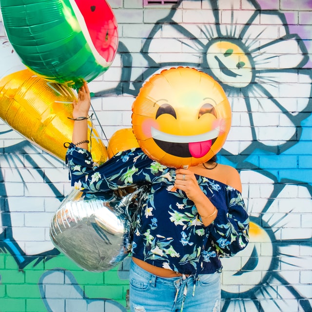 woman hiding her face behind balloons 11 reasons why you should start yoga