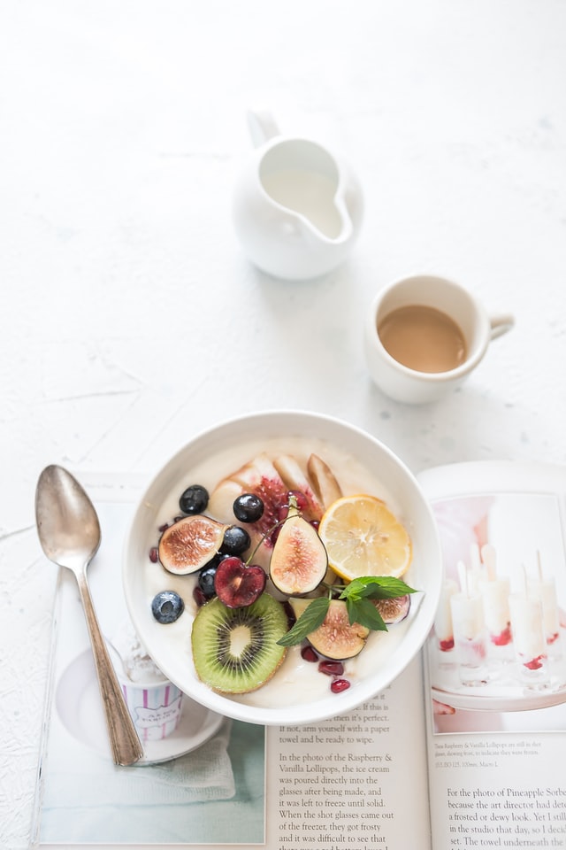 healthy breakfast bowl with yogurt and fresh fruits on breakfast table how to practice self-care at work