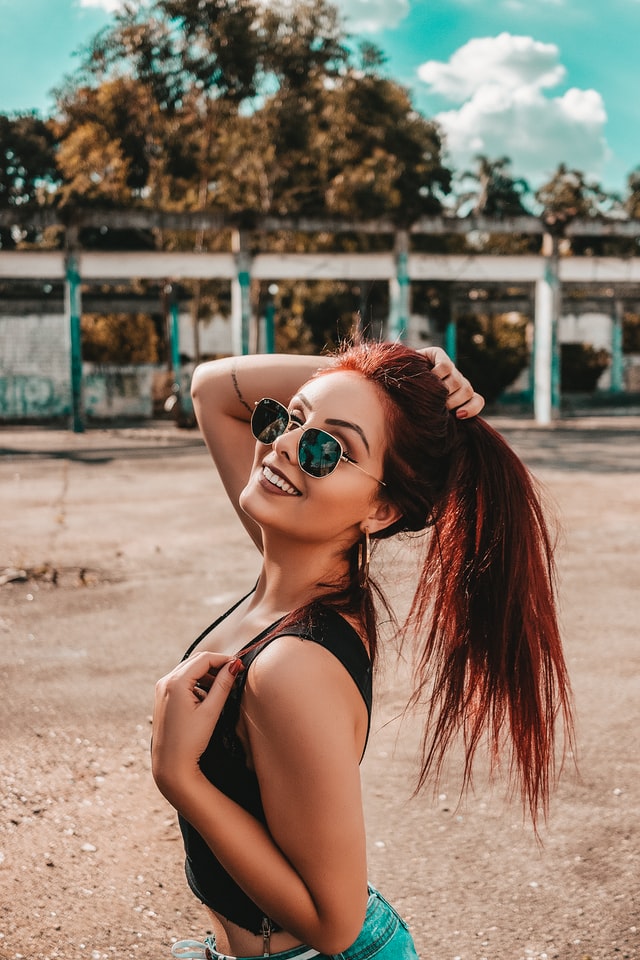 woman with red hair posing in front of camera 12 self-care ideas for summer confidence photo shoot