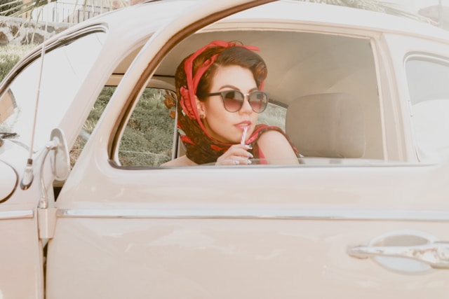 the picture shows a woman in a car taking a road trip by herself and the blog post is about summer self-care ideas