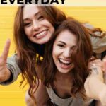 two female friends with long brown hair having fun posing for camera 13 feel-good things to do every day