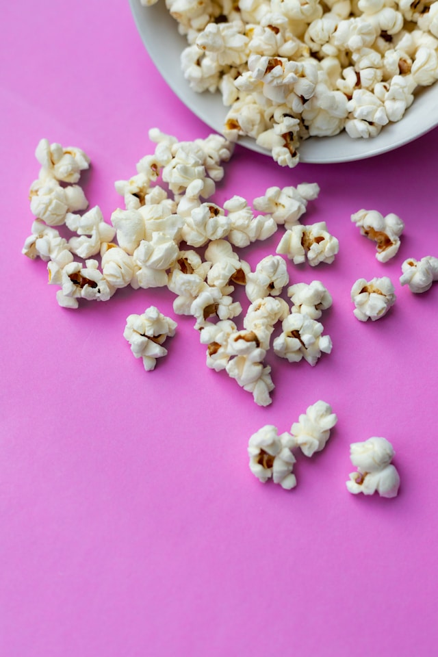 image showing popcorn on pink table blog post is about feel good activities