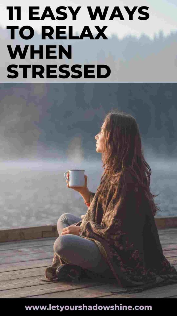 woman sitting on pier at a lake enjoying a cup of coffee 11 easy ways to relax when stressed