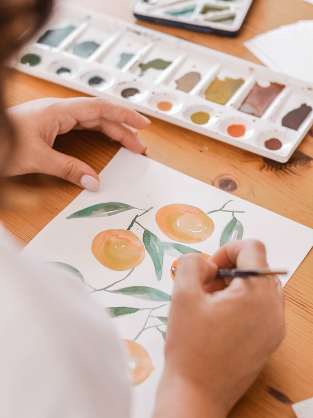 close up of woman hands drawing a picture on a wooden table 11 easy ways to relax when stressed