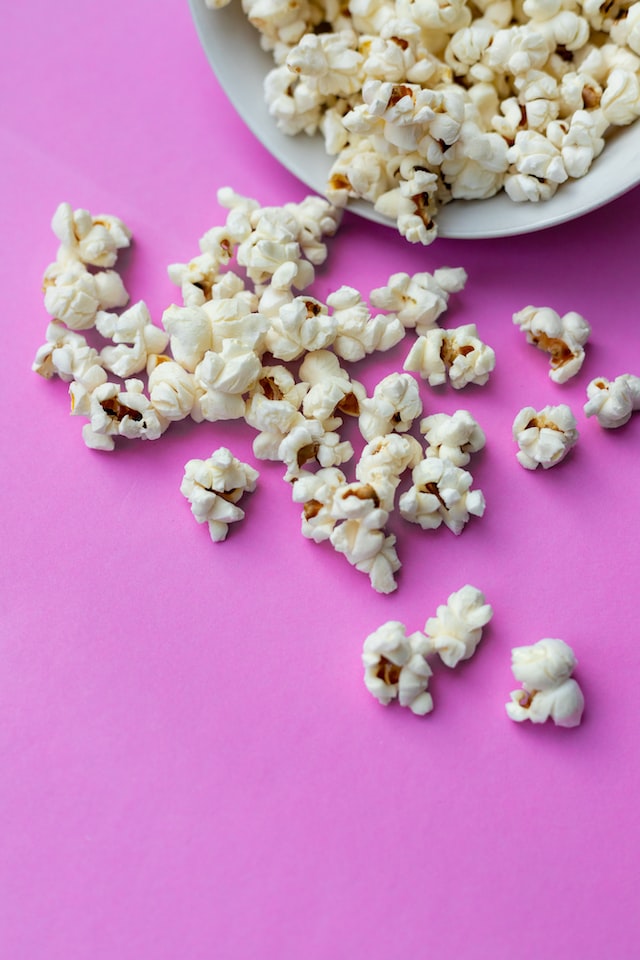 popcorn on pink table 12 self-care ideas for autumn movie night