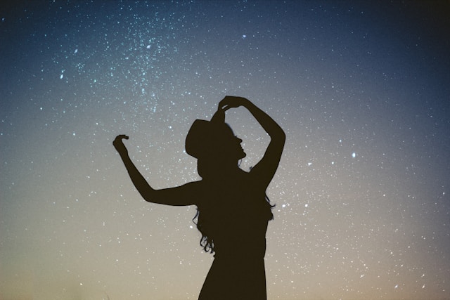 picture showing a dreamy image of a woman dancing blog post is about mindful glow up tips