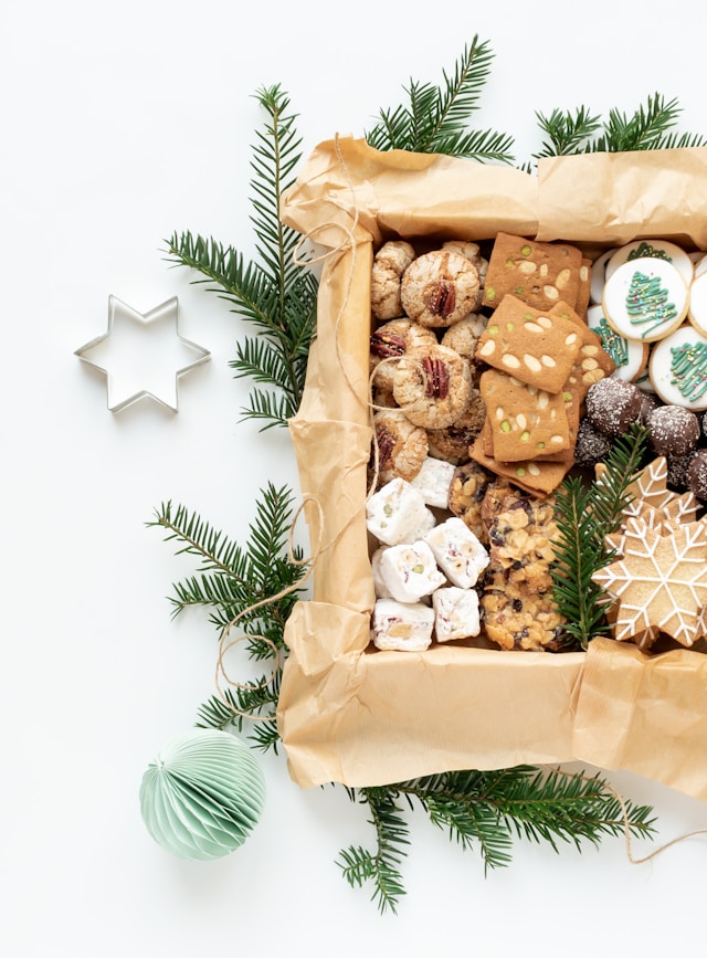 the picture shows beautifully decorated homemade Christmas cookies placed in a box on a table and the blog post is about metal health at Christmas and tips on navigating the festive season
