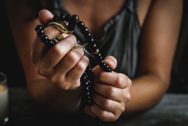 close up of woman holding mala beads in her hands black mala beads gifts for yoga lovers