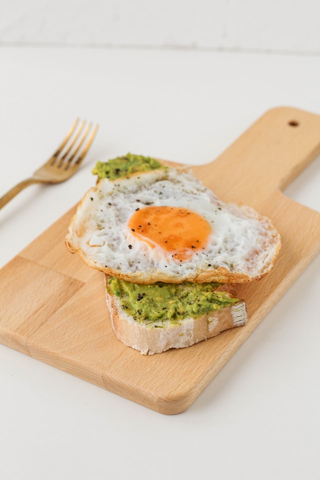 slice of bread topped with avocado and egg post yoga snacks