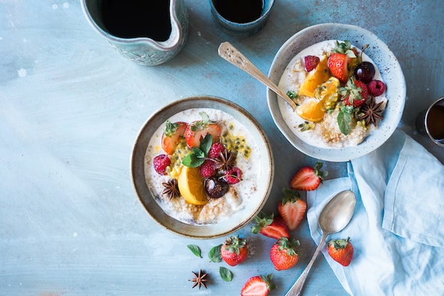 close up of two bowls filled with yogurt and fresh fruits post yoga snacks