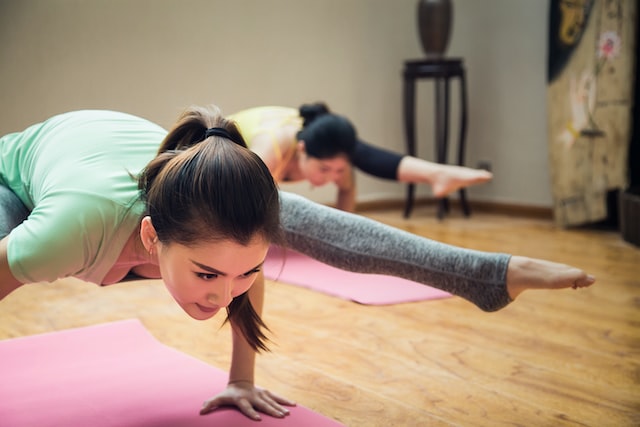 image showing women in yoga class doing arm balances post yoga snacks