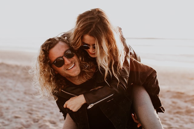 image showing couple laughing man carrying woman how to set healthy boundaries in relationships