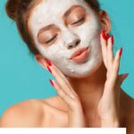 Pinterest image showing woman with facial mask posing into the camera enjoying a self care moment blog post is about pamper yourself activities