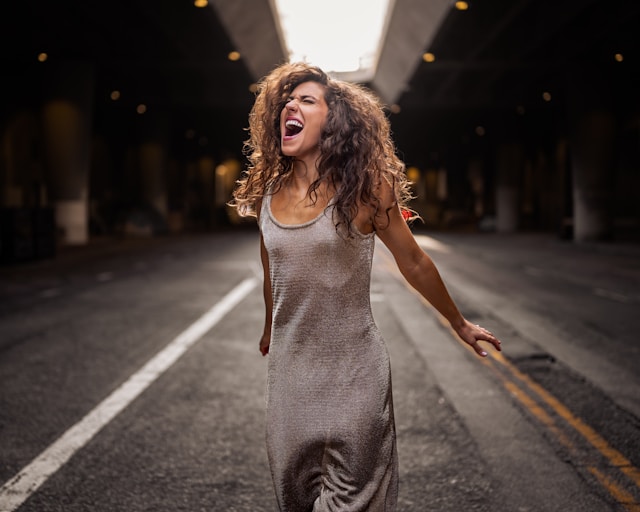 image showing a woman walking in street looking very happy and content with herself blog post is about self love exercises