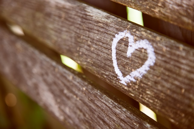 close up of wooden bench showing a heart drawn on it with chalk treat yourself ideas self-love