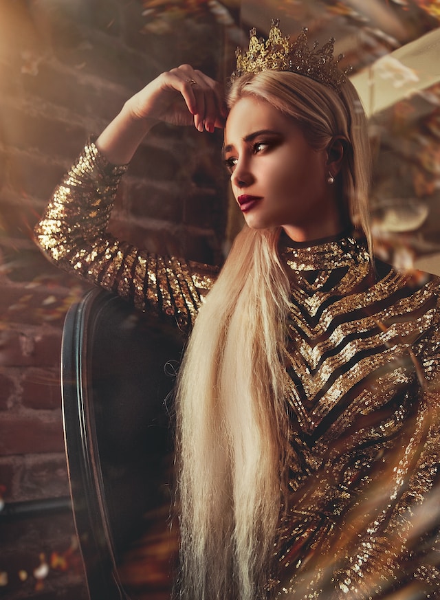 image showing blonde woman with long hair wearing a golden and black dress looking majestic treat yourself ideas with a spa day