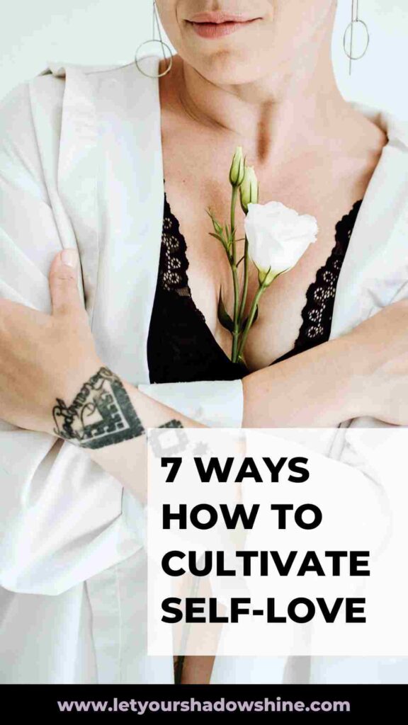 image showing close up of woman chest it is a woman giving herself a big hug holding a white rose between her breasts how to cultivate self-love
