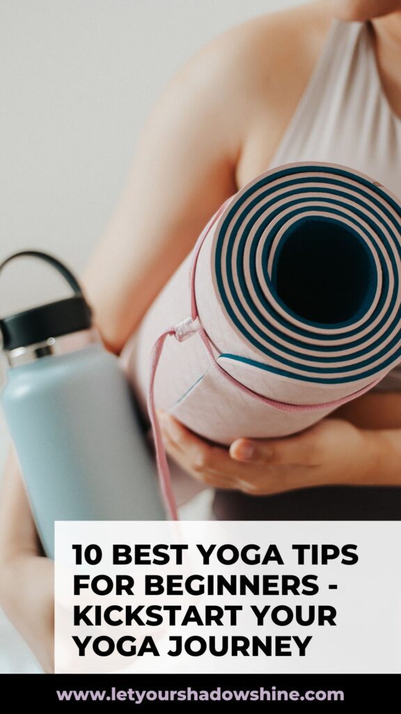 pinterest image showing close up of woman holding a yoga mat and a water bottle blog post is about yoga tips for beginners