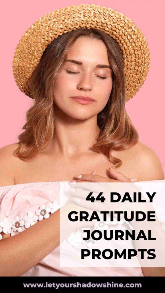 blonde woman with straw hat and closed eyes, both hands on her heart enjoying a moment of deep gratitude daily gratitude journal prompts