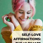 woman with pink hair wearing yellow top smiling and feeling happy from within self-love affirmations