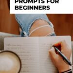 Pinterest pin image shows a close up of a woman sitting and writing into a journal and holding a cup of coffee in her other hand the blog post is about shadow work journal prompts for inner healing and transformation