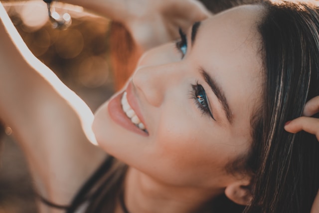 image is showing a close up of a woman's head and the woman is smiling the blog post is about positive morning affirmations