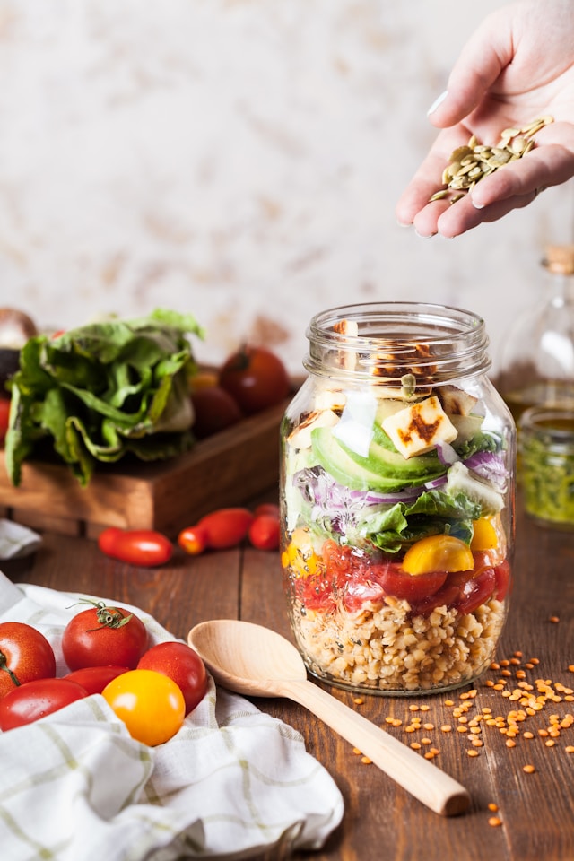 image showing a close up on a glass jar with a healthy salad inside blog post is about meal prep for busy professionals