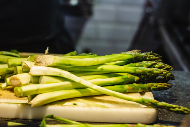 image shows a close up on fresh asparagus and the blog post is about meal prep for busy professionals