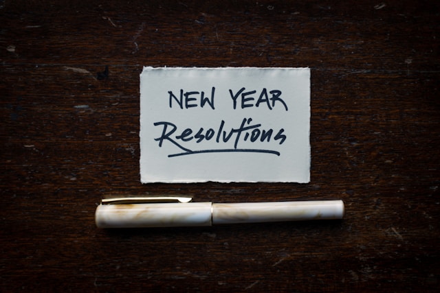 image shows a close up of a note saying new year resolutions blog post is about self reflection journal prompts for the end of the year