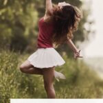 Pinterest pin image shows a woman in a nature setting the woman is dancing and one can feel happiness from that image the blog post is about personal growth tips