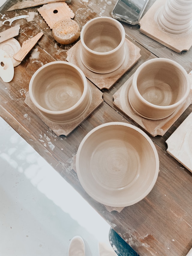 image shows pottery pots placed on a table and the blog post is about personal growth goals examples