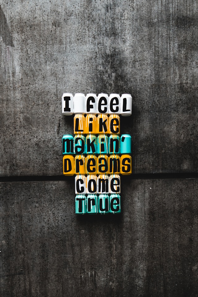 image shows close up of writing saying I feel like making dreams come true placed on a wooden background blog post is about personal growth ideas