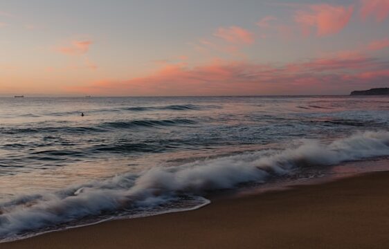 image shows a calming morning beach setting and the blog post is about morning yoga stretches from a certified yoga teacher