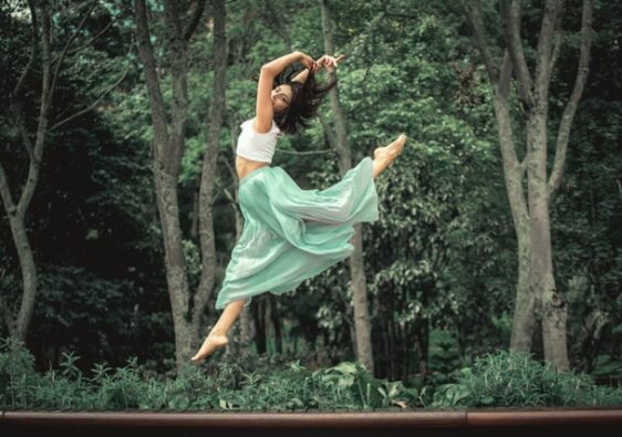 image showing a woman jumping into the air with a nature setting in the background the blog post is about simplify life