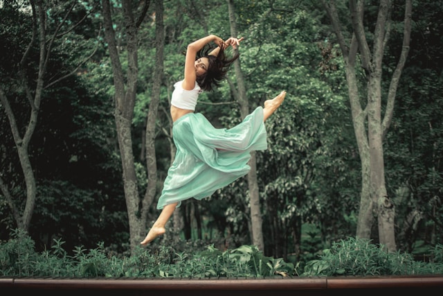 image showing a woman jumping into the air with a nature setting in the background the blog post is about simplify life